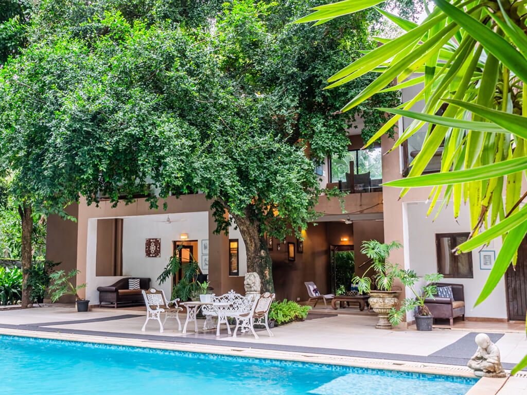 Large villas in Alibaug with swimming pool deck and outdoor bar area for group events.