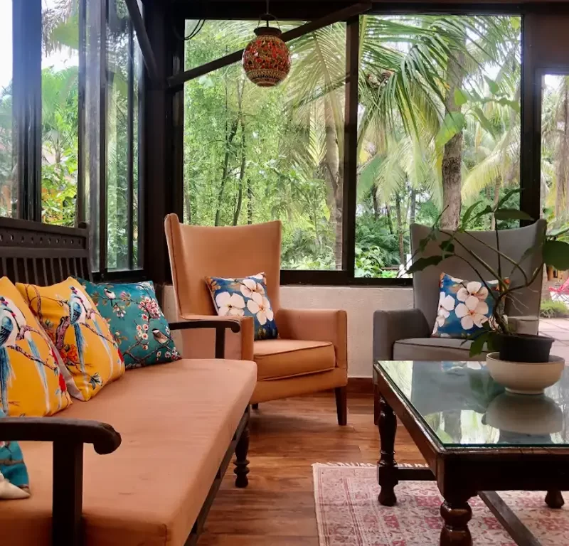 Living lounge area at Mango Beach House Awas overlooking lush garden
