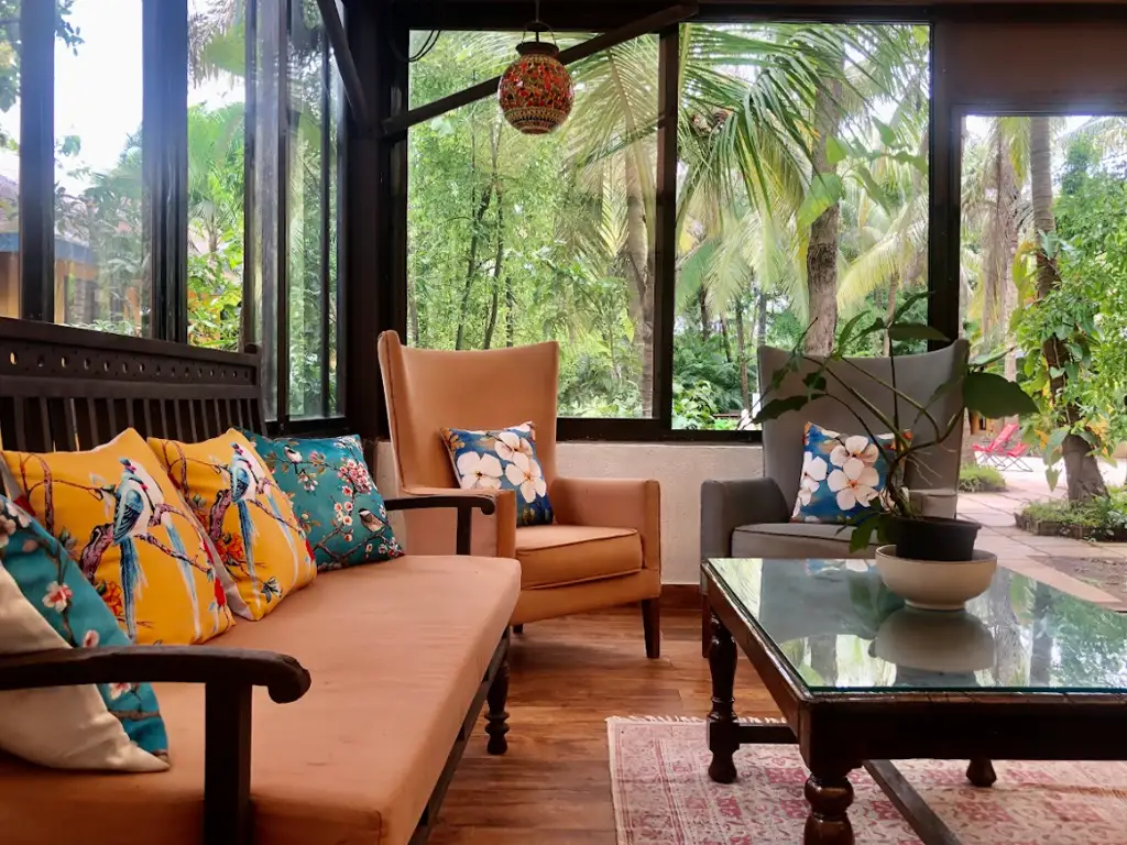 Living lounge area at Mango Beach House Awas overlooking lush garden