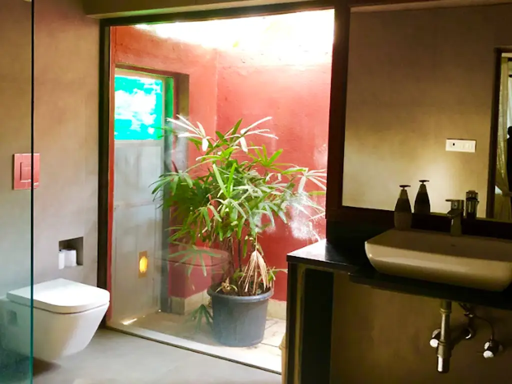 Luxury villa bathroom at Casa Mango Alibaug with natural light and courtyard view