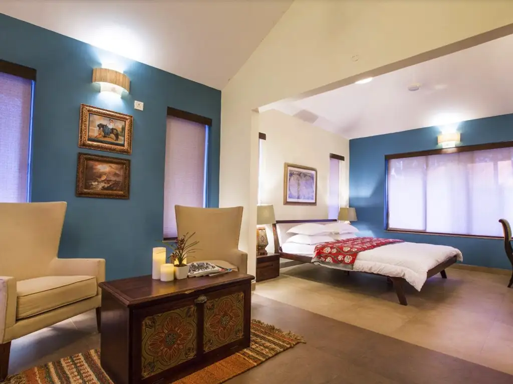 Master bedroom with seating area at Mango Beach House Awas Alibaug